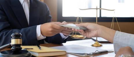 lawyer or judge is taking a bribe. In the client's courtroom at the lawyer's office In order to bribe to gain an advantage in the form of lawsuits, the concept of bribery and corruption in law photo