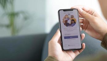 A working from home employee is downloading the Microsoft Teams social platform, ready for remote working in isolation from home photo