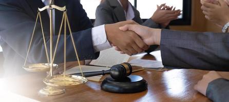 Businessman shaking hands to seal a deal with his partner lawyers or attorneys discussing a contract agreement. photo