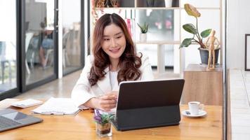 Young asian businesswoman beautiful charming smiling and using laptop computer in office. photo