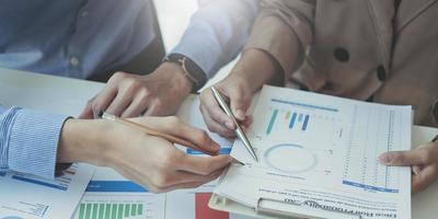 Close up of accountant working and analyzing financial reports project accounting with chart graph and calculator in modern office  finance and business concept. photo