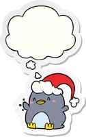 cartoon penguin wearing christmas hat and thought bubble as a printed sticker vector