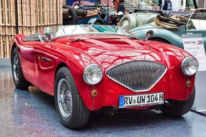 FRIEDRICHSHAFEN - MAY 2019 red AUSTIN-HEALEY 100 BN1 cabrio roadster 1955 at Motorworld Classics Bodensee on May 11, 2019 in Friedrichshafen, Germany photo