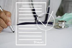 Woman doctor with stethoscope Checking documents. photo