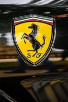 GERMANY, FULDA - JUL 2019 A close-up of the Ferrari logo on a black car photo