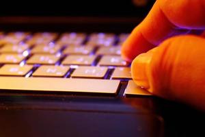 man using laptop, searching web, browsing information, having workplace at home, soft focus picture, Vintage concept, night photo