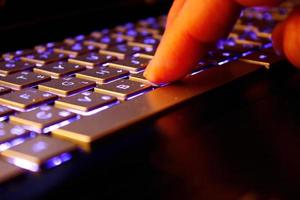 man using laptop, searching web, browsing information, having workplace at home, soft focus picture, Vintage concept, night photo
