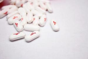 WASHINGTON, USA  July 21 2022  Bottle Of Tylenol Extra Strength With Many Pills On A Wooden Table Which Was Sold Out During Covid-19 time, headache, Painkillers photo