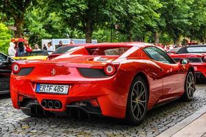 GERMANY, FULDA - JUL 2019 red FERRARI 458 SPIDER coupe was introduced at the 2011 Frankfurt Motor Show. This convertible variant of the 458 Italia features an aluminium retractable hardtop which, acco photo