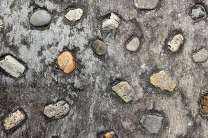 Wall round stone pebble rock texture background photo