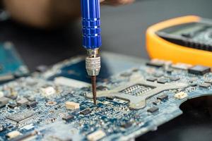 Technician repairing inside of mobile phone. Integrated Circuit. the concept of data, hardware, technology. photo