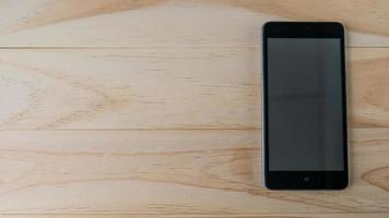 mobile phone on wood table for communication content. photo