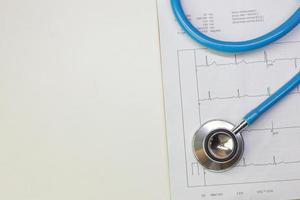 Blue stethoscopes and  Electrocardiography  chart close up image. photo