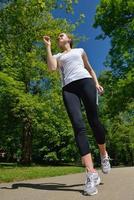 Young beautiful  woman jogging at morning in park photo