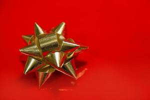 Shiny gold satin ribbon on red background. photo