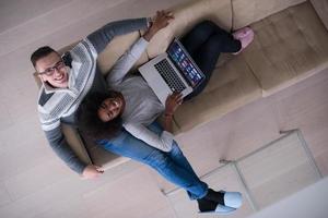 happy multiethnic couple relaxes in the living room photo