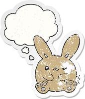 cartoon rabbit and thought bubble as a distressed worn sticker vector