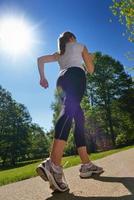 Young beautiful  woman jogging at morning in park photo