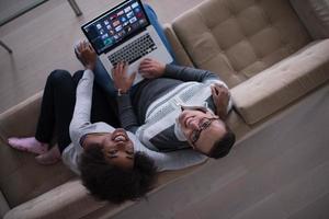 happy multiethnic couple relaxes in the living room photo