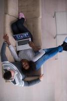 happy multiethnic couple relaxes in the living room photo