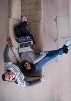 happy multiethnic couple relaxes in the living room photo