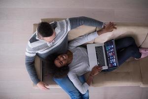 happy multiethnic couple relaxes in the living room photo