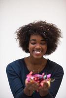 African American woman blowing confetti in the air photo