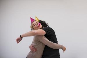 couple in party hats blowing in whistle photo