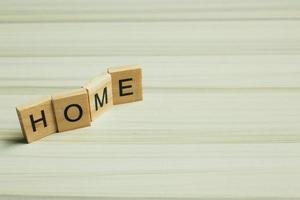 Home word on wood plate abstract background. photo