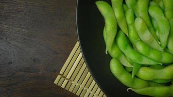 Edamame  in black plate top view image for food content. photo