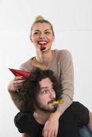 couple in party hats blowing in whistle photo