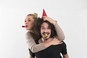 couple in party hats blowing in whistle photo
