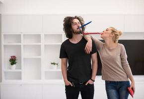 couple in party hats blowing in whistle photo