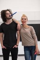 couple in party hats blowing in whistle photo