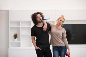 couple in party hats blowing in whistle photo