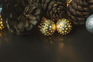 The christmas ball and Pine cones  on black  background. photo