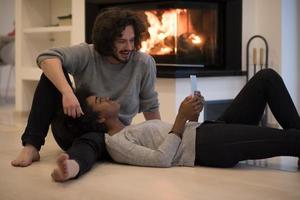 multiethnic couple using tablet computer on the floor photo