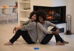 multiethnic couple with tablet computer on the floor photo