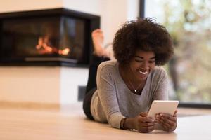 black women using tablet computer on the floor photo