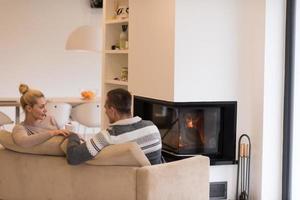 Young couple  in front of fireplace photo