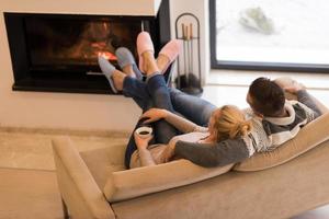Young couple  in front of fireplace photo