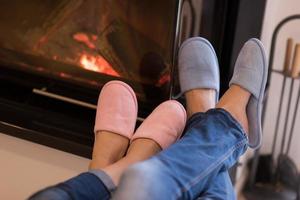 Young couple  in front of fireplace photo