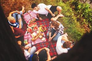 top view of group friends enjoying picnic time photo