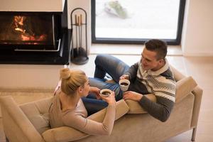 Young couple  in front of fireplace photo