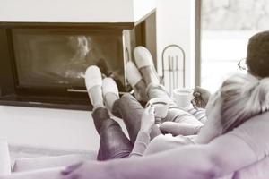 Young multiethnic couple  in front of fireplace photo