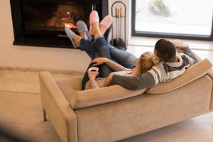 Young couple  in front of fireplace photo