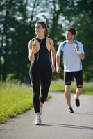 Young couple jogging at morning photo