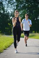 Young couple jogging at morning photo