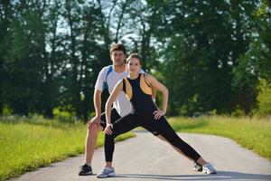 Couple doing stretching exercise  after jogging photo