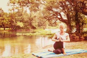 woman meditating and doing yoga exercise photo